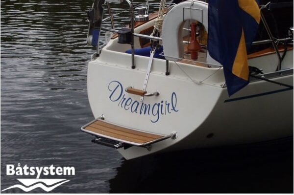 teak stern platform installed on a white sailing yacht